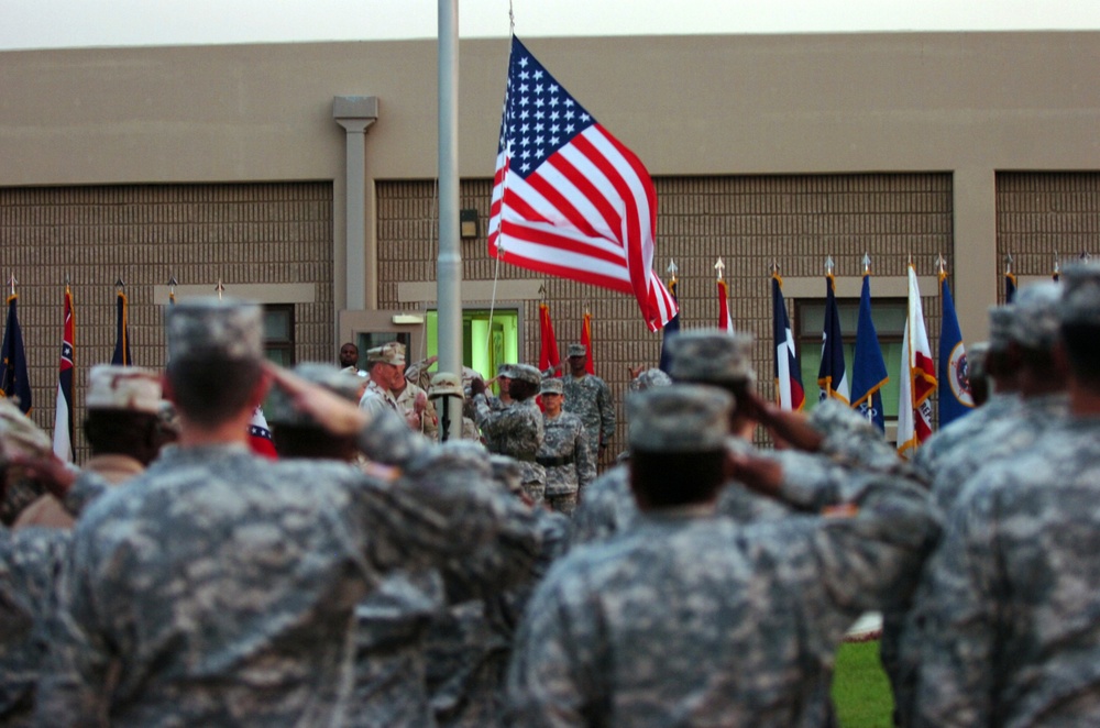 CAMP ARIFJAN, Kuwait (November 11, 2006) --Soldiers from Area Support Group - Kuwait salute as the flag is lowered during a retreat ceremony remembering Veterans Day on camp Nov. 11.