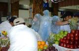 BALAD, Iraq (Nov. 11, 2006) - Workers at DFAC 3 place their eagle ice sculpture in the center of the fruit arrangement for the Veterans Day competition. DFAC 3 won first place in the small dining facility category.