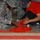 BALAD, Iraq (Nov. 11, 2006) - Spc. Benita Barnes, a cook with the 368th Cargo Transportation Company out of Ft. Story, Va., and a civilian contractor add red food coloring to white rice. The rice was then used to create a large American flag and was sprea