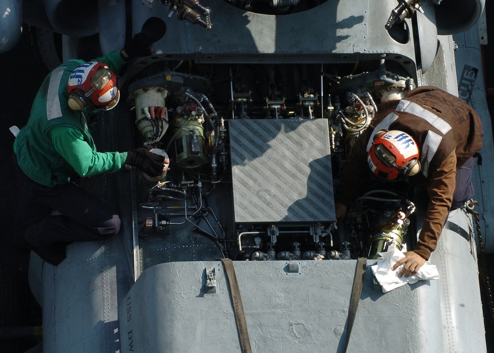 Sailors perform routine maintenance on an SH-60F Seahawk