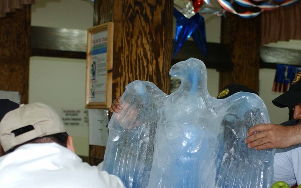 Workers at DFAC 3 place their eagle ice sculpture in the center of the fruit arrangement for the Veterans Day competition. DFAC 3 won first place in the small dining facility category.