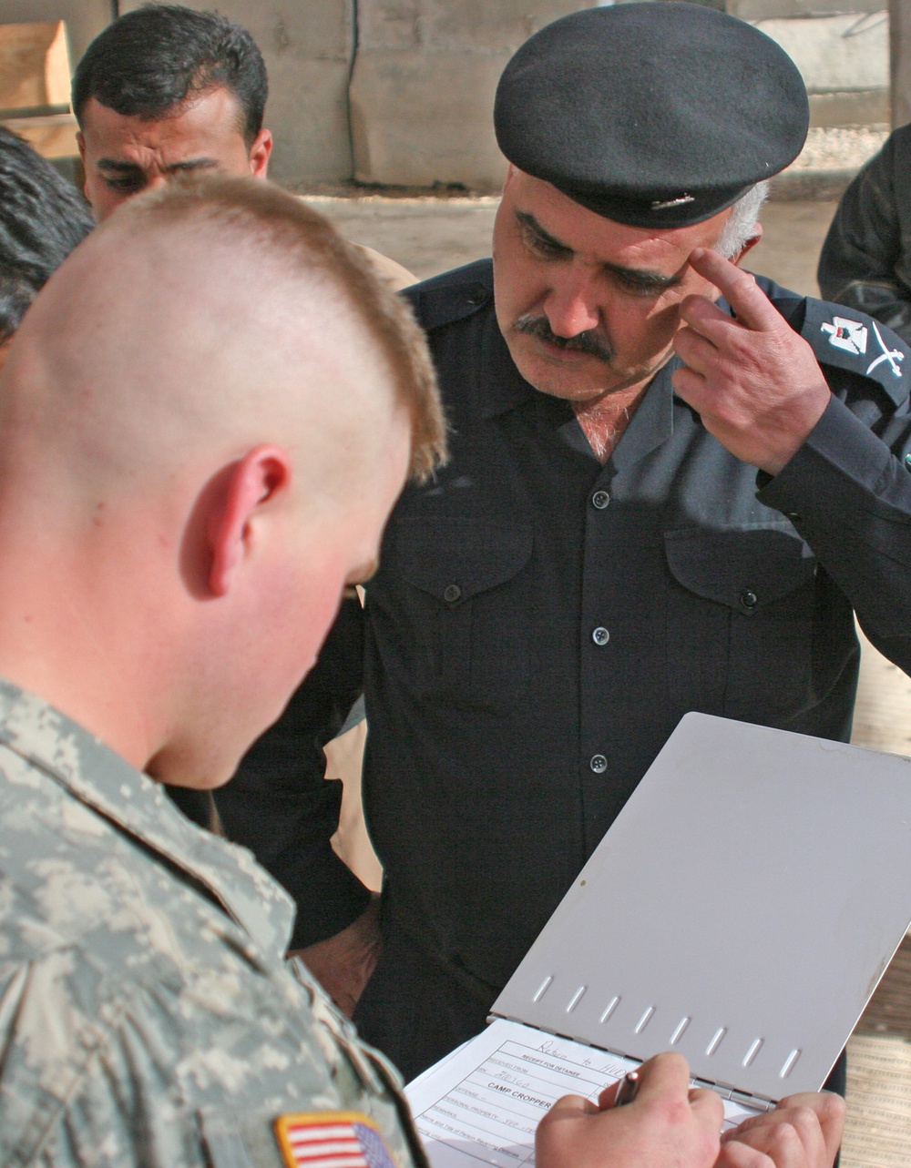 Iraqi Police take female detainee into custody from coalition forces