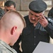 Iraqi Police take female detainee into custody from coalition forces