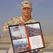 CAMP ARIFJAN, Kuwait - Sgt. Scott Leber, an operations NCO with the 385th Signal Company, holds the flag from &quot;Hamburger Hill&quot; and a plaque containing pictures of his uncle, former Spc. Joe Leber, with the raised flag on the hill in May 1969. Scott flew t