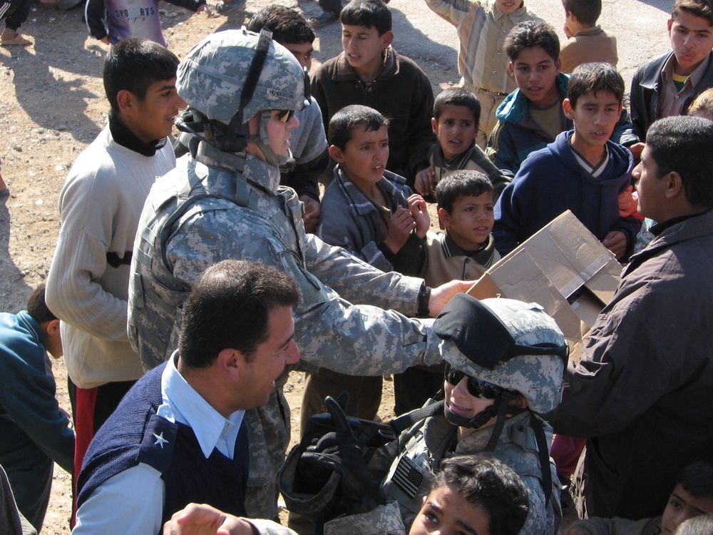 Soldiers and Iraqi Police work together to help village