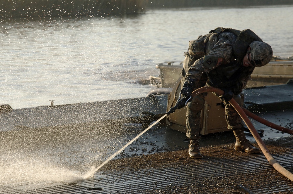 Soldiers build an assault, float bridge outside Camp Taji