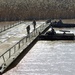 Soldiers build an assault, float bridge outside Camp Taji