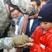 Soldiers hand out school supplies at a boys' school in Mosul