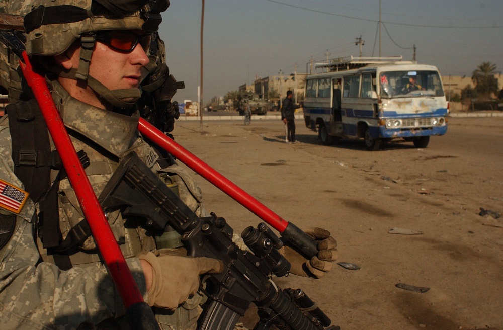 Iraqi police and U.S. Soldiers conduct a cordon and search