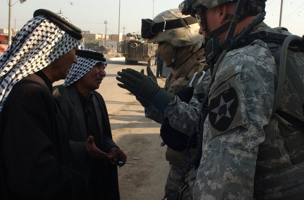Iraqi police and U.S. Soldiers conduct a cordon and search