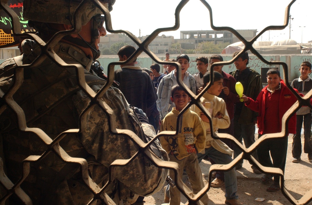 Iraqi police and U.S. Soldiers conduct a cordon and search