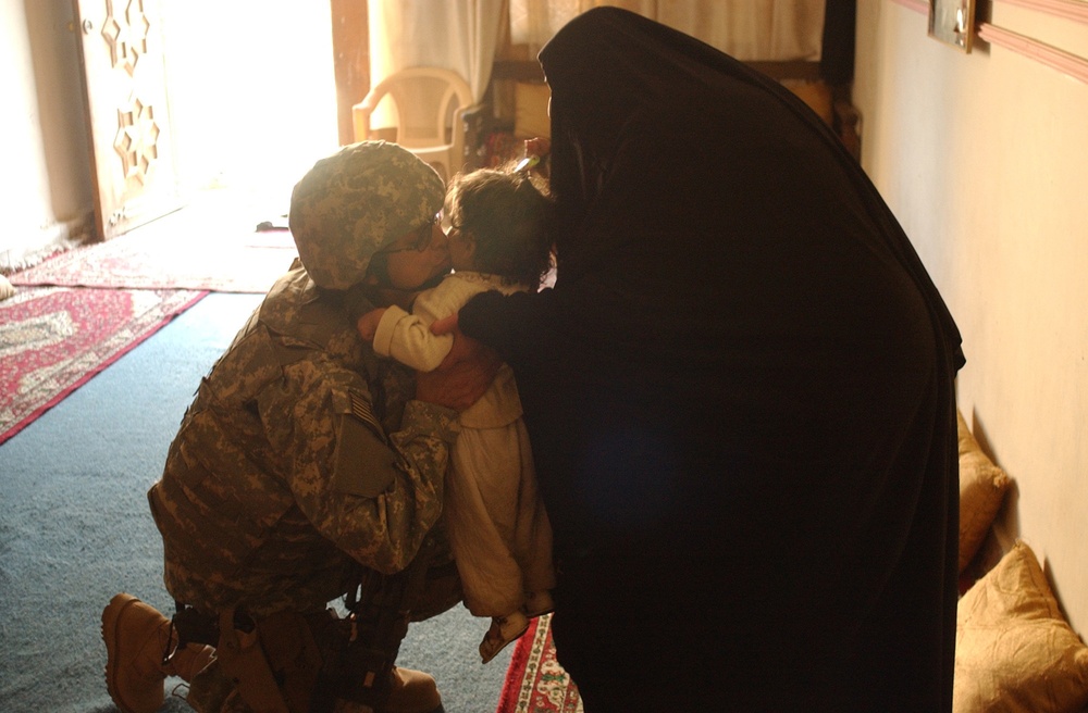 Iraqi police and U.S. Soldiers conduct a cordon and search