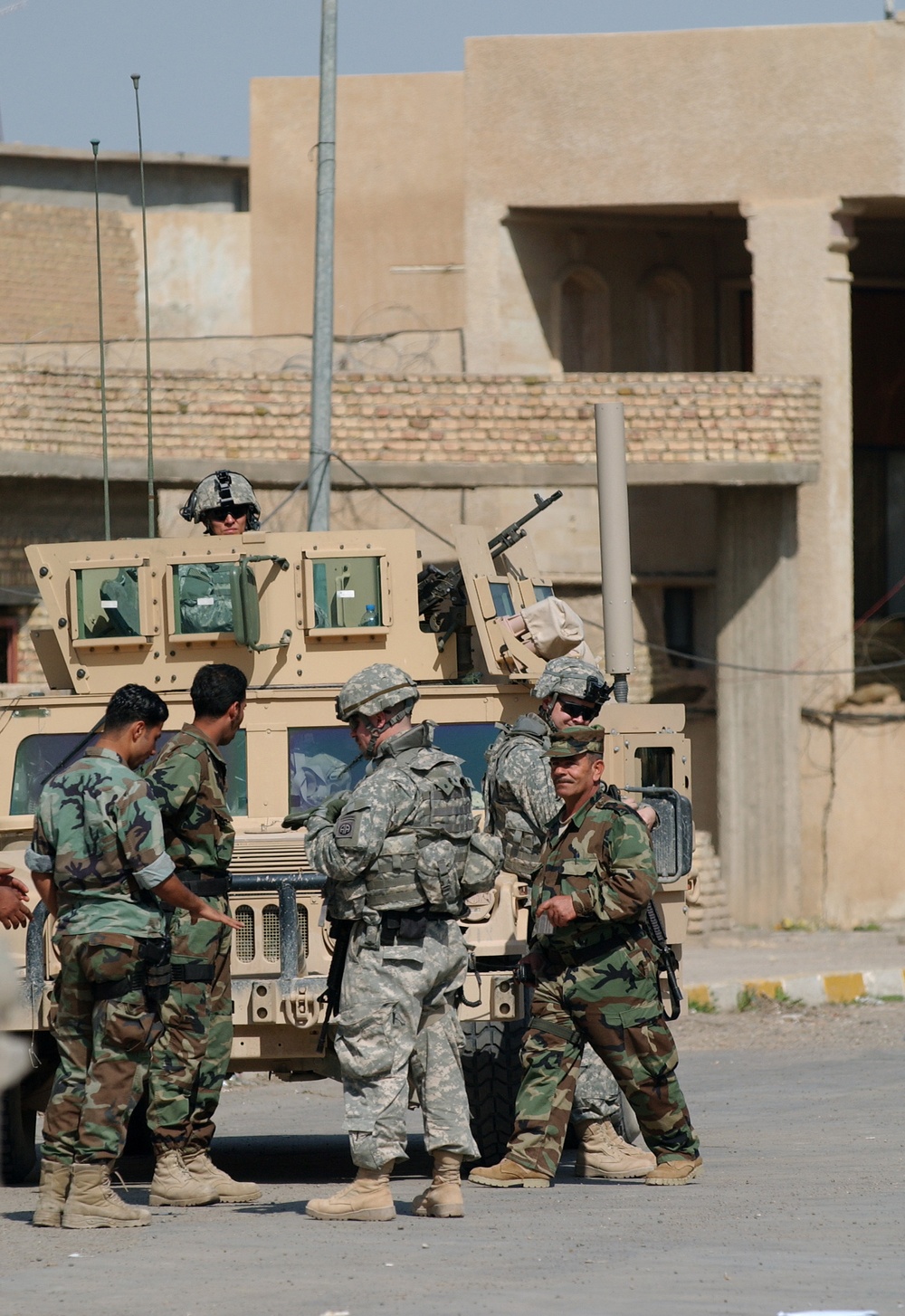 Soldiers speak with locals in Samarra