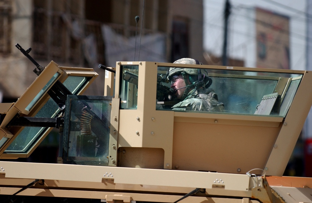 Soldiers speak with locals in Samarra