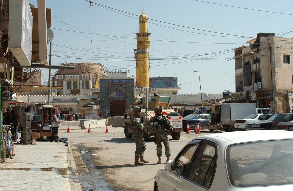 Soldiers speak with locals in Samarra