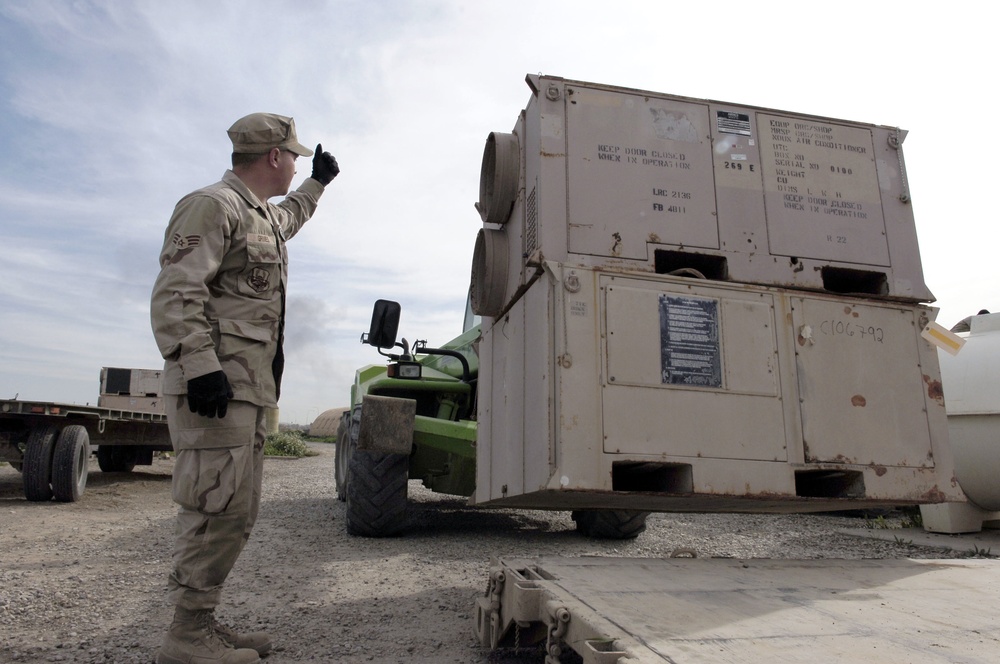 Soldiers load an Environmental Control Unit