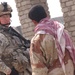 U.S. Army Soldier, Iraqi police talk during patrol in Mosul