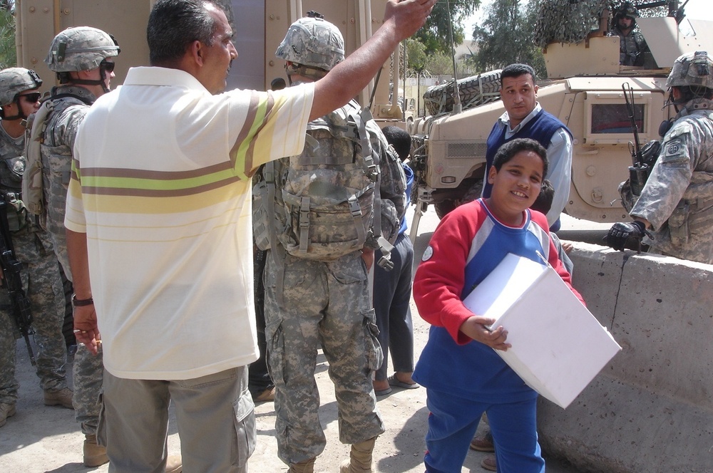 Humanitarian aid brings smiles to Baghdad neighborhood