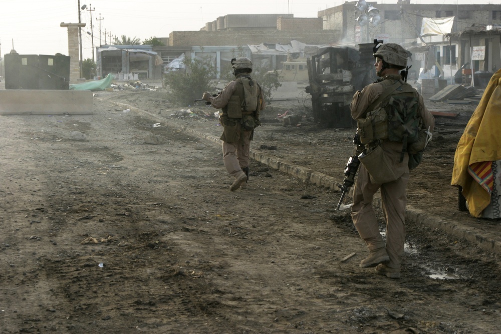 Patrolling the marketplace after an attack in Saqlawiyah