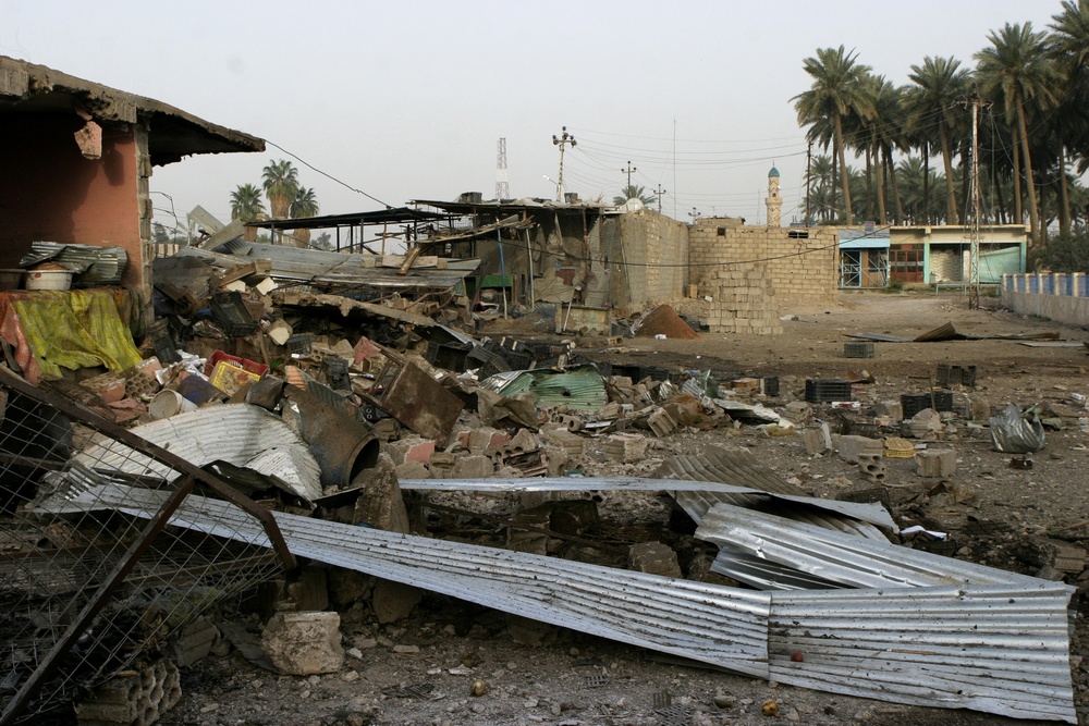 Patrolling the marketplace after an attack in Saqlawiyah