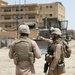 Patrolling the marketplace after an attack in Saqlawiyah