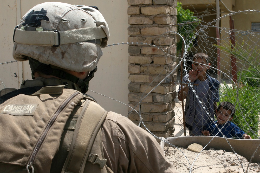 Patrolling the marketplace after an attack in Saqlawiyah