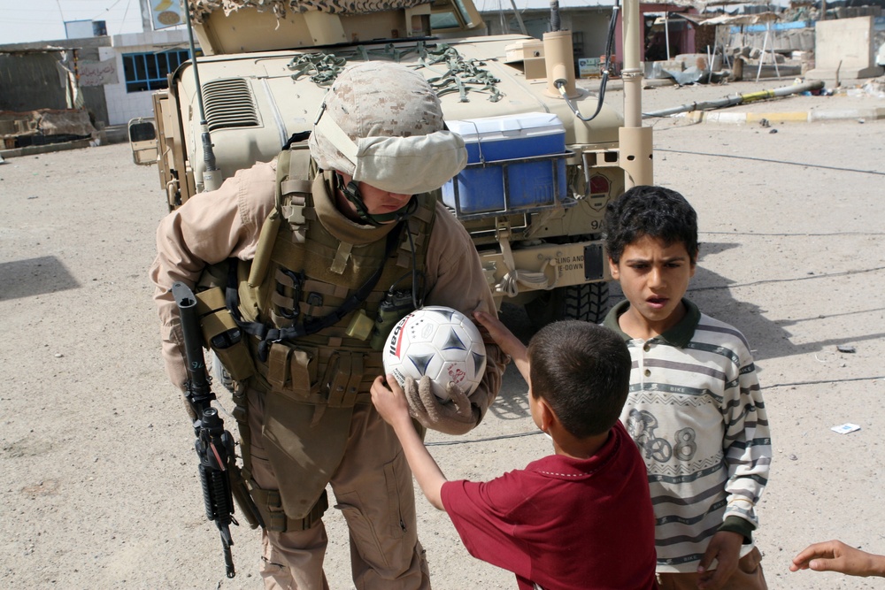 Patrolling the marketplace after an attack in Saqlawiyah