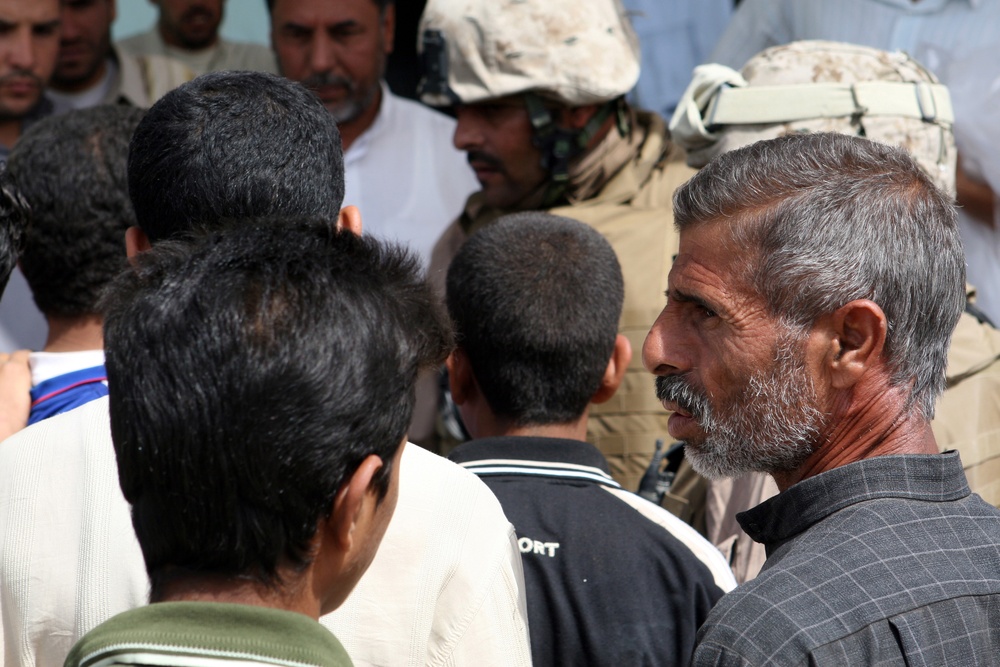 Patrolling the marketplace after an attack in Saqlawiyah