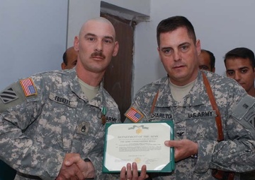 Raider Soldier escorts wounded Iraqi Police officer to Baghdad
