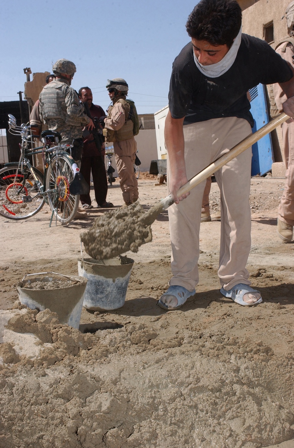 US and Iraqi Soldiers Guard and Support Reconstruction Efforts