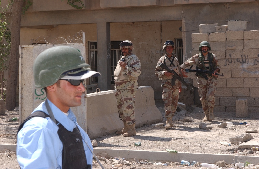 US and Iraqi Soldiers Guard and Support Reconstruction Efforts