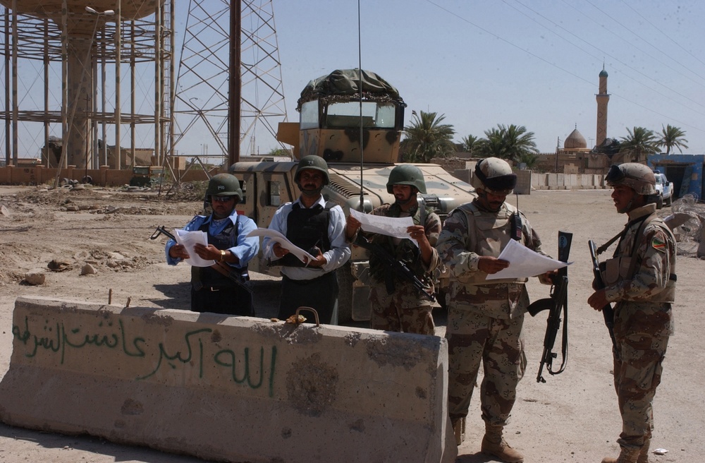 US and Iraqi Soldiers Guard and Support Reconstruction Efforts