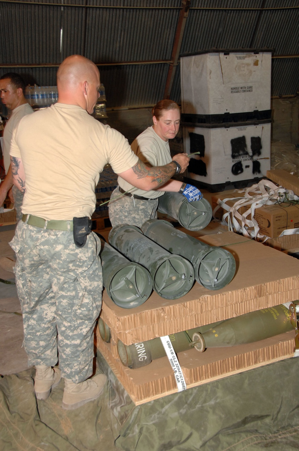 Soldiers Load Pallets With Howitzer Rounds