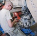 Mechanics work on up-armored Humvee
