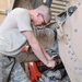 Army mechanics work on up-armored Humvee
