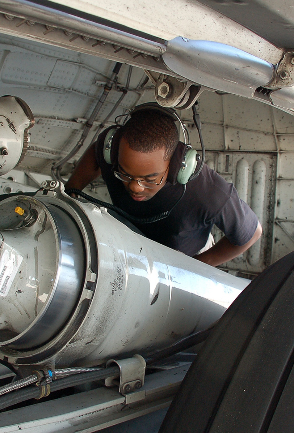 Airman Checks Main Landing Gear