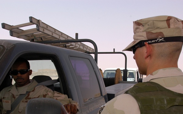 Airman checks IDs at entry control point