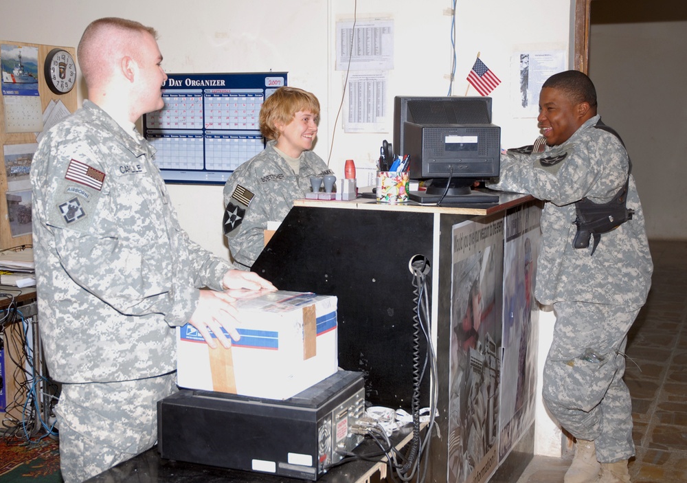 Postal clerks deliver pieces of home to Soldiers
