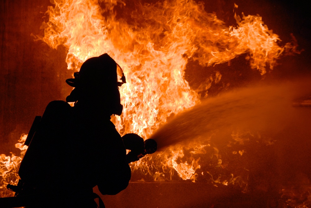 firefighter combats fire during training