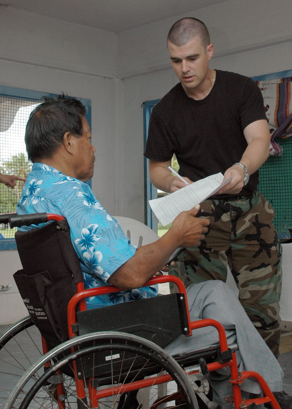 Tech. Sgt Rayno Boivin assists a patient