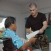 Tech. Sgt Rayno Boivin assists a patient
