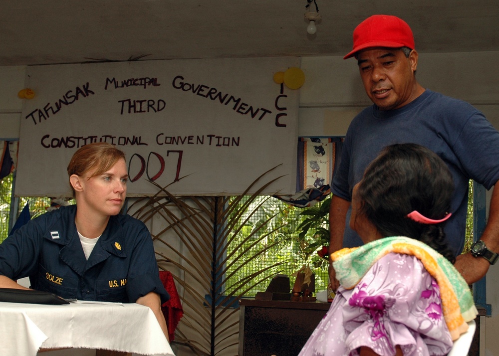 Lt. Elizabeth Solze explains a patient's diagnosis to a translator
