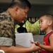 Capt. Yves Nepomuceno helps a Micronesian boy during medical civic action p