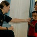 Lt. j.g. Natile Derfus shows Micronesian children how to blow bubbles