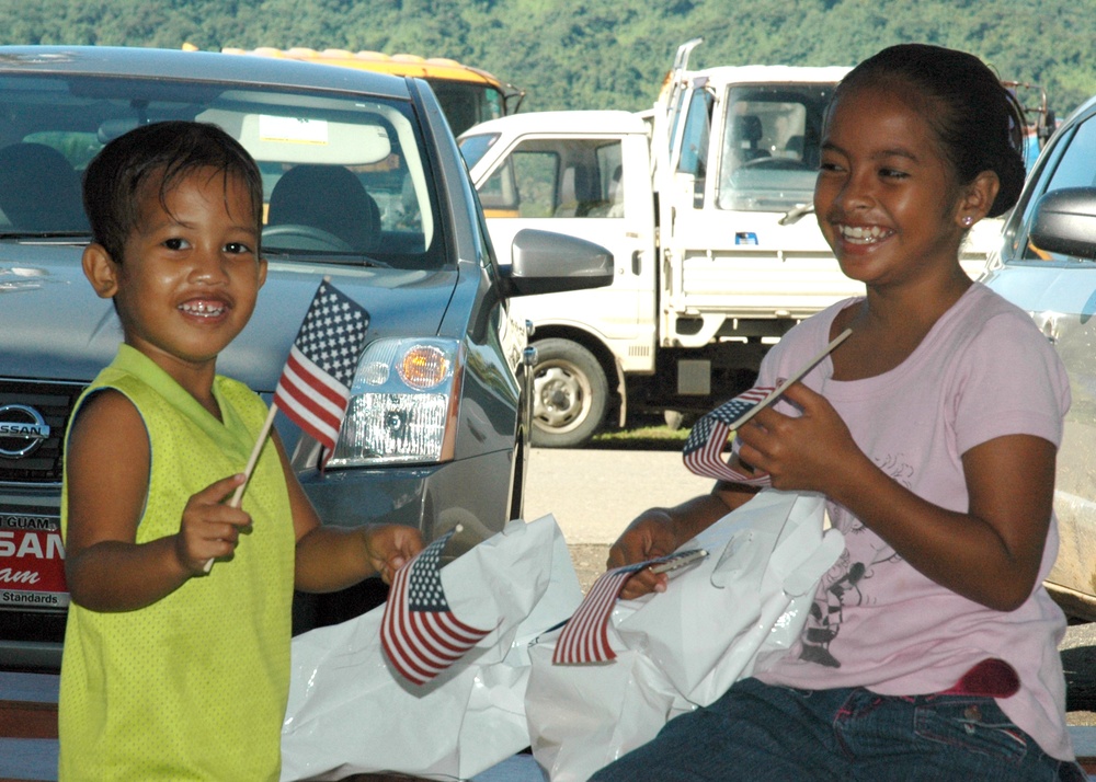 Micronesian children wave American flags