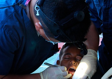 Lt. Cmdr. Paul Lim administers dental aid