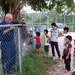 Japanese Children watch as sailors repair Tenshin-ryo Children's hom