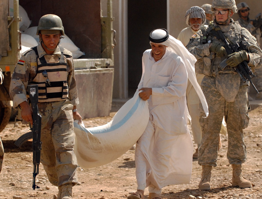 Iraqi Soldiers Hand Out Food After Clearing Operation