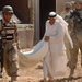 Iraqi Soldiers Hand Out Food After Clearing Operation