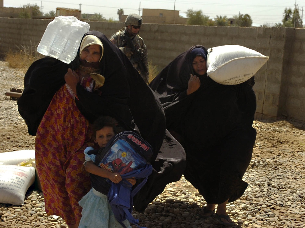 Iraqi Soldiers Hand Out Food After Clearing Operation